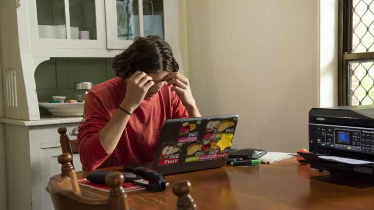 Teen looking stressed at computer