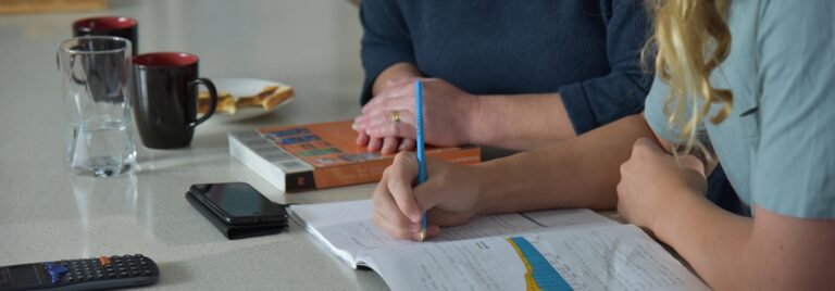 Mother helps son complete homework